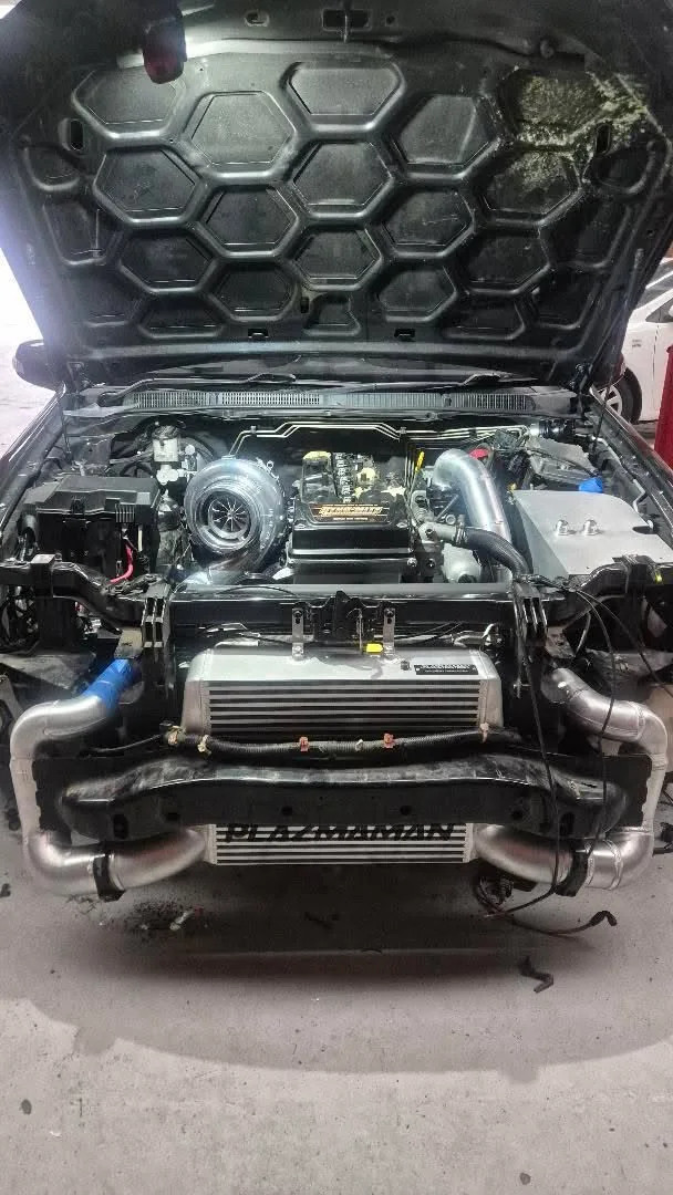 Turbocharged engine bay with intercooler and fabricated alloy pipework