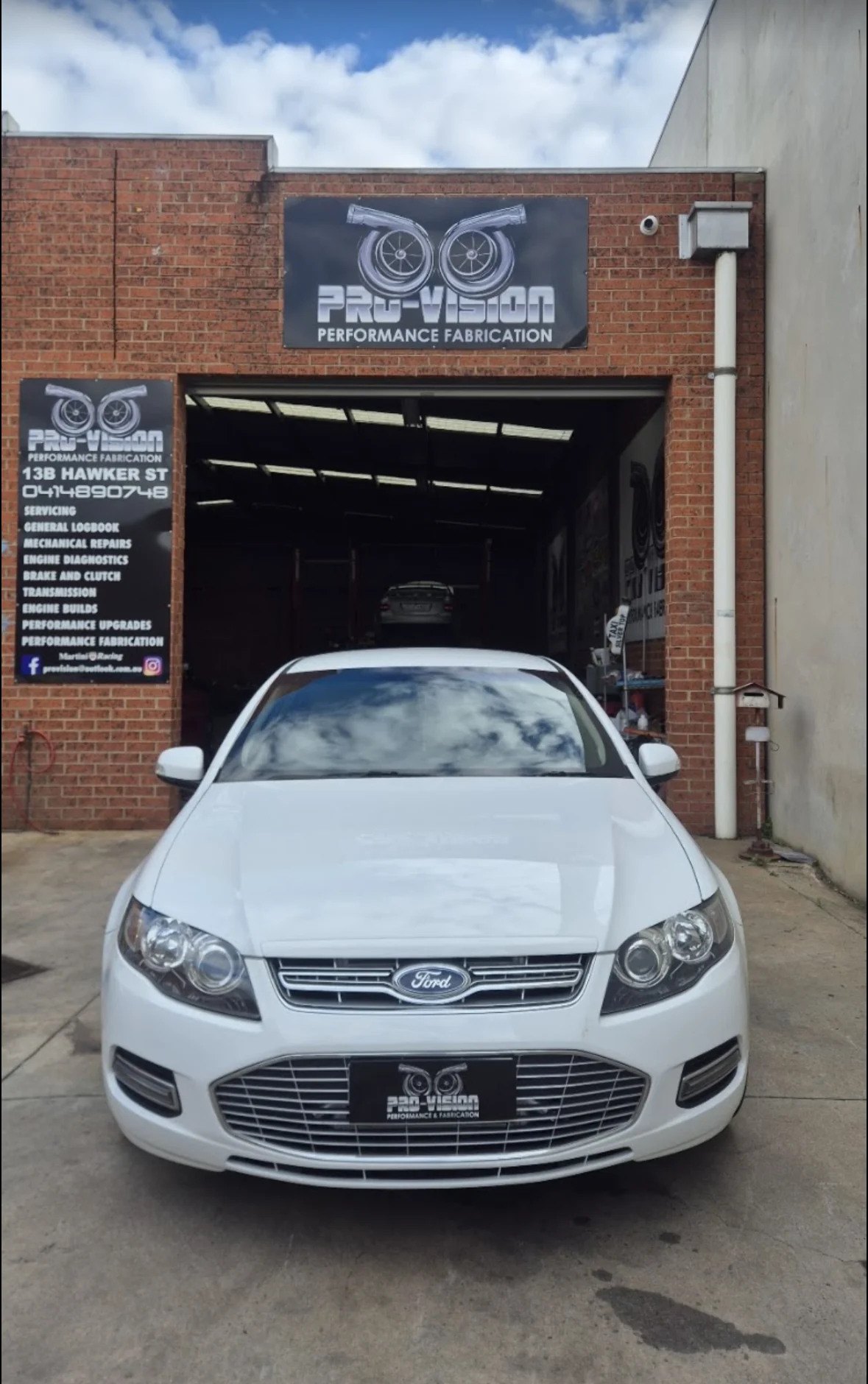White Ford at the Pro-Vision workshop entrance