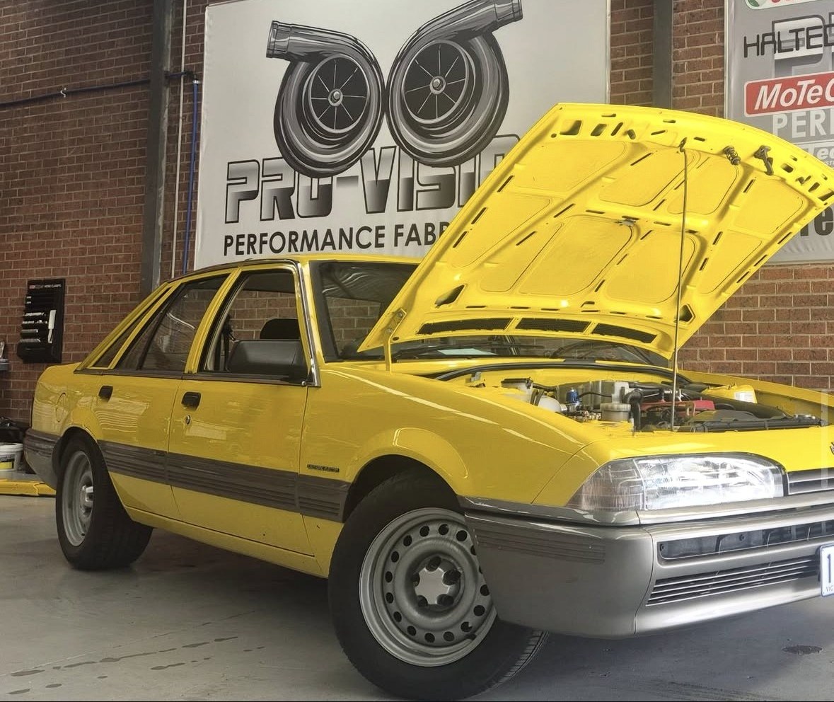Yellow Holden VL Turbo in the workshop